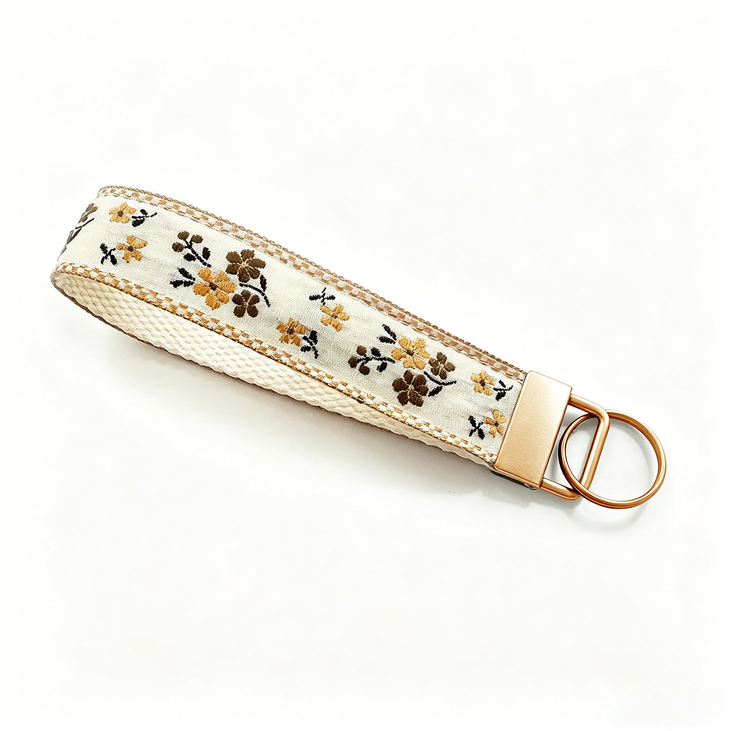 QIUDU floral embroidered keychain size reference on hand