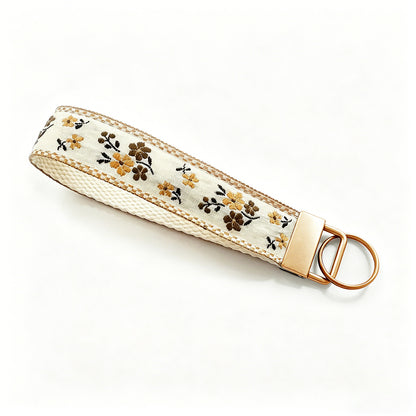 QIUDU floral embroidered keychain size reference on hand