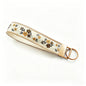 QIUDU floral embroidered keychain size reference on hand