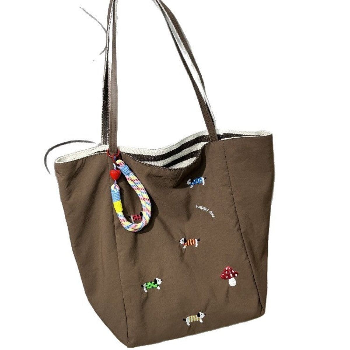 QIUDU embroidered canvas tote bag in red colorway lifestyle shot