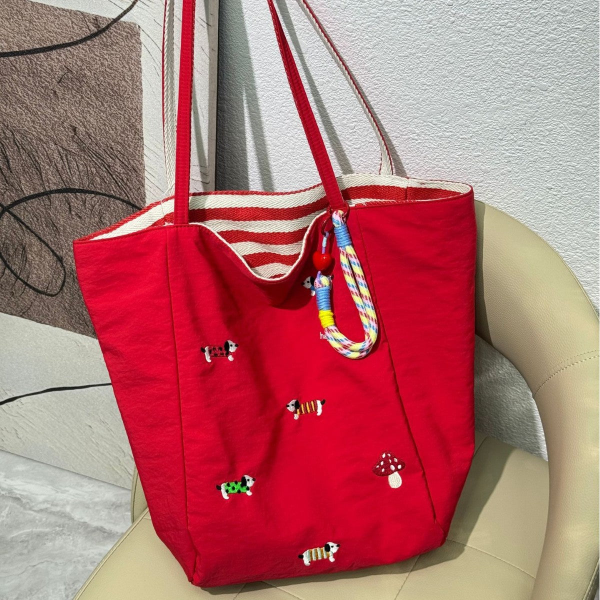 QIUDU embroidered canvas tote bag side view showing double-sided design