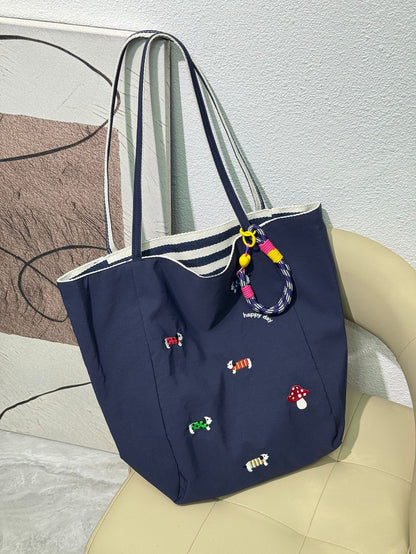 QIUDU embroidered canvas tote bag in brown colorway shoulder carry
